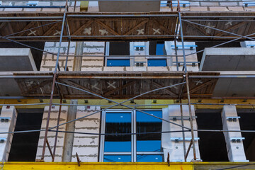 Insulation of the exterior walls of a building under construction.