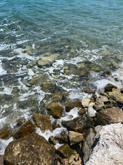 sea wave on rocky beach, very clean water