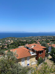 Fototapeta na wymiar ocean view from mountain in Greece, tiled orange roofs