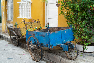 Fototapeta na wymiar Colorful carriages for the transport of goods, yellow and blue on the street