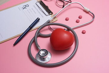 Stethoscope with heart. Stethoscope and red heart on wooden table. Hospital life insurance concept. World heart health day idea. Medicine or pharmacy concept. Empty medical form ready to be used.