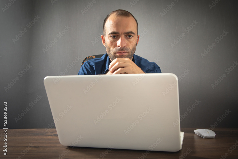 Poster Caucasian man working with laptop computer.