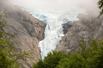 Amazing view of the glacier in Jostedalsbreen national park, Norway on a cold foggy day