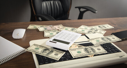 Computer mouse, calculator, money and computer keyboard.