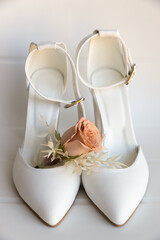 Bride's white weeding shoes on a white background,isolated.Front view.Vertical format