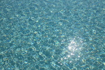 Sun reflection on the surface of a pool on a bright day