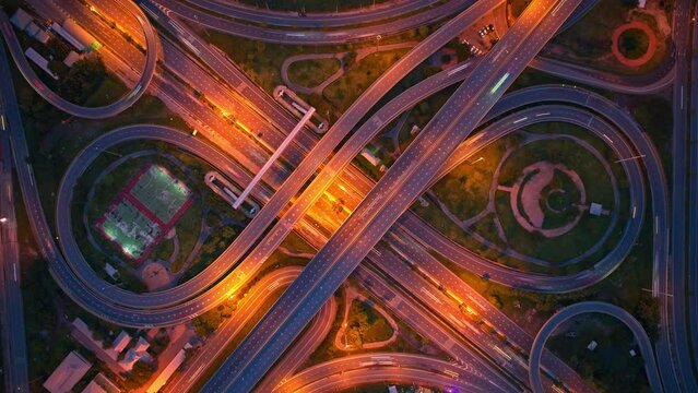 4K : Aerial view shot of fast moving above interchange and motorway road. night traffic time lapse. infrastructure in thailand. hyperlapse. traffic in Bangkok, Thailand
