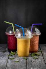 Mix of fruit smoothies with a straw. Vegan detox drinks. Non alcoholic beverages
