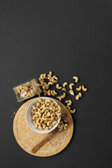Top view of cashew nuts on a gray background.Copy space.Vertical format