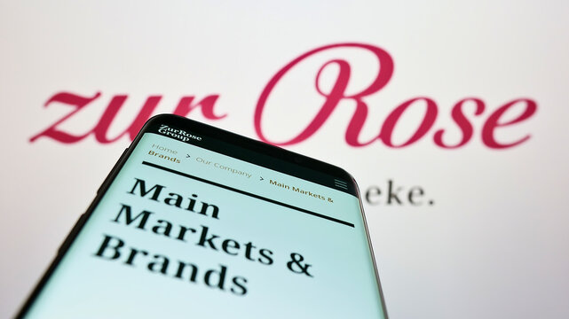 Stuttgart, Germany - 08-28-2022: Mobile phone with website of Swiss pharmacy company Zur Rose Group AG on screen in front of business logo. Focus on top-left of phone display.