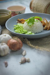 Hainanese chicken rice with fried chicken, fried chicken served with sweet dipping sauce and chicken broth, Asian style, street food commonly sold in Asia.