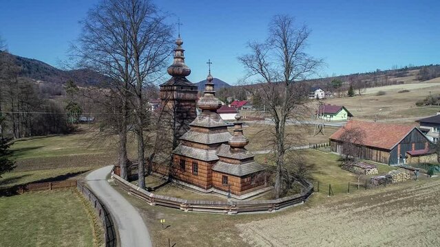 Wooden church in Kwiatoń, Poland.  Built in 17th century. Originally an eastern orthodox church (tserkva), now a Roman Catholic church. UNESCO World Heritage Site. Aerial video