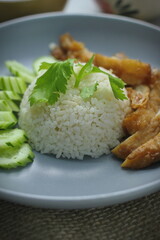 Hainanese chicken rice with fried chicken, fried chicken served with sweet dipping sauce and chicken broth, Asian style, street food commonly sold in Asia.