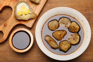 empek empek with cuka or vinegar sauce in a white bowl. emepek enpek is a typical food from Palembang Indonesia. pempek palembang. Indonesian dish