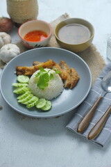 Hainanese chicken rice with fried chicken, fried chicken served with sweet dipping sauce and chicken broth, Asian style, street food commonly sold in Asia.
