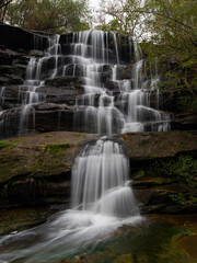 Fototapeta na wymiar Beautiful water flowing in rocky cascade.
