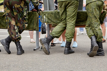 the military stand in camouflage with their backs in boots.