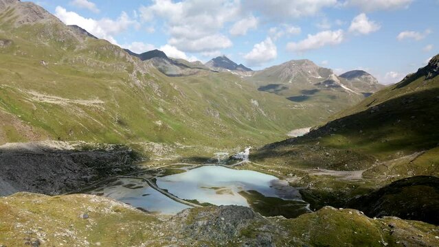 Spinning aerial view of the high mountain lake in the valley of Zinal, Switzerland