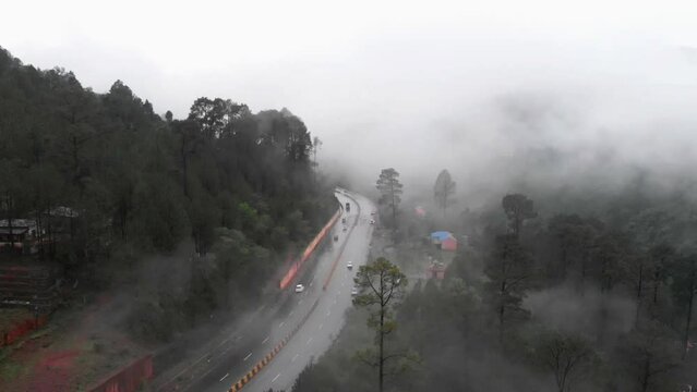 Aerial View Of Muree Expressway Through Dense Fog. Pan Right