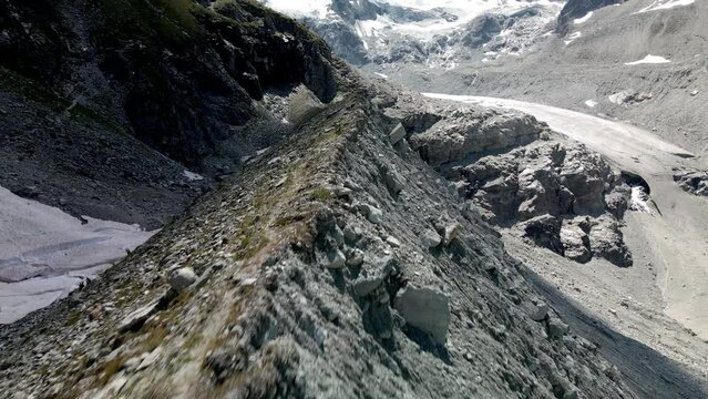 Aerial FPV like shot moving forward tracing the shape of the mountain in Zinal, Switzerland