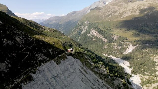 Aerial view of a mountain refuge on top of the mountain surrounded by the forest in Zinal, Switzerland