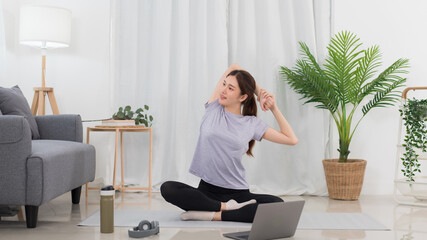 Yoga exercise concept, Asian woman hold hands behind back to stretching before yoga training online