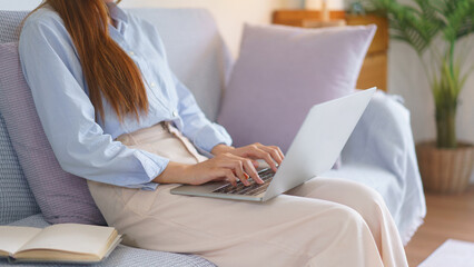 Business at home concept, Businesswoman reads data on laptop to analysis marketing plan of startup