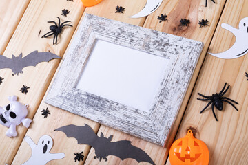 Frame with copy space and multiple halloween toys on wooden surface - Powered by Adobe