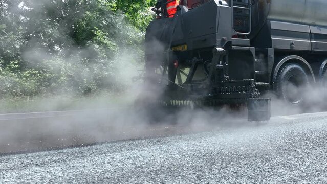 Heavy Machinery Resurfacing a Road Using Micro Asphalt Dressing