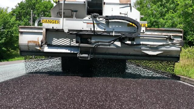 Heavy Machinery Resurfacing a Road Using Micro Asphalt Dressing