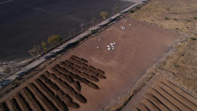 aerial pull up of large plot of compost farm land in mexico