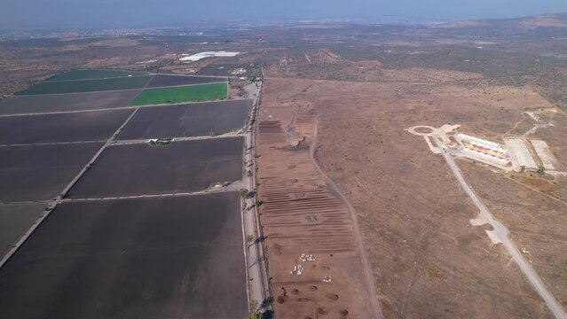 aerial push in of large compost farm land landscapes in mexico