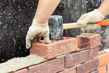 Construction of a brick wall. Brick laying. selective focus
