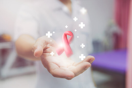 Medicine doctor holding red ribbon on 3d hologram modern virtual screen interface. hiv awareness concept, world AIDS day, world hypertension day, Medical and futuristic concept.