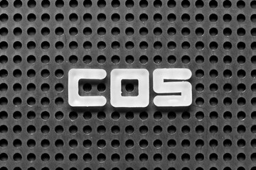 White alphabet letter in word COS (Abbreviation of Cost of sales, Class of service, Cosine) on black pegboard background