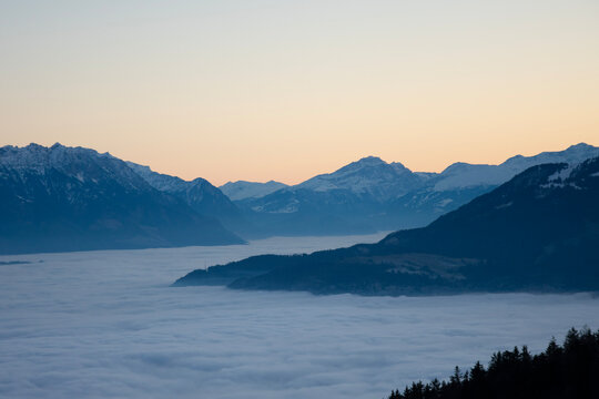 sunset behind the mountains, mountains floating on fog © Piriya