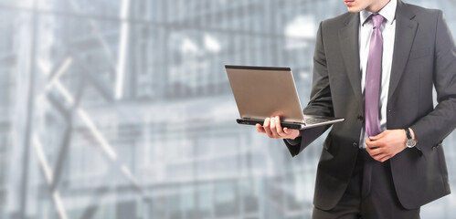 businessman works on laptop at the office - People isolated on modern office background