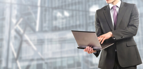 businessman works on laptop at the office - People isolated on modern office background