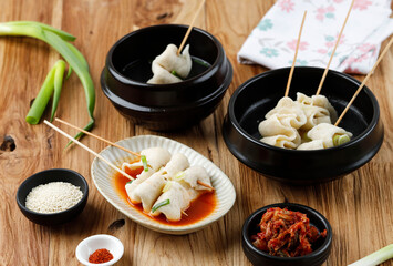Odeng Guk with Various Broth, Spicy, Meat, and Chicken Broth. Served with Kimchi, Sesame Seed, and Gochugaru