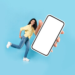 Cheerful Middle Eastern Lady Showing Huge Smartphone Over Blue Background