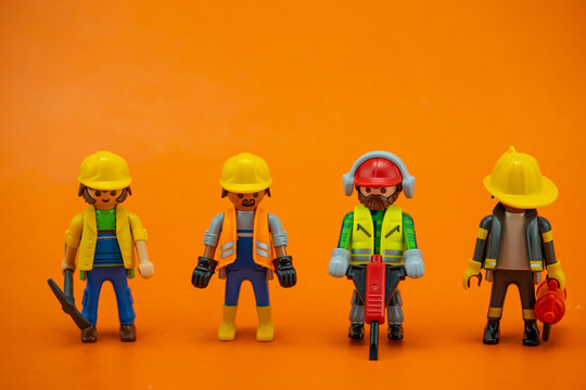 Bangkok, Thailand - May. 15, 2022: Studio shot of Lego construction engineer.Legos are a popular line of plastic construction toys on an orange background,manufactured by Playmobil Malta Ltd. in Malta