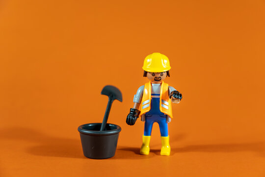 Bangkok, Thailand - May. 15, 2022: Studio shot of Lego construction engineer.Legos are a popular line of plastic construction toys on an orange background,manufactured by Playmobil Malta Ltd. in Malta