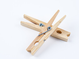 Stainless steel spring type wooden clothes pegs isolated on a white background
