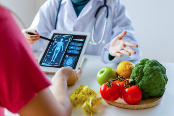 nutritionist female doctor using digital mobile tablet with virtual graphic icon diagram and...