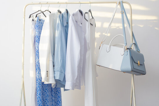 female white and blue capsule summer wardrobe in  white room