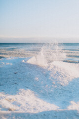 Ice waves on the beach in winter time