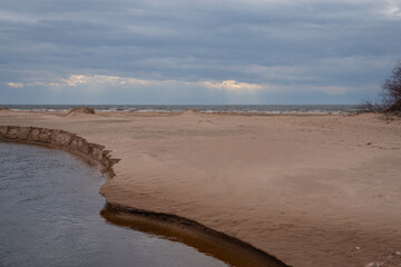 Vitrupe river delta among sandy dunes by Baltic sea on early spring
