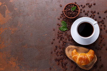 Cup of black coffee and croissant