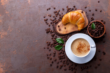 Cup of black coffee and croissant
