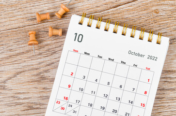 The October 2022 Monthly desk calendar for 2022 year and wooden push pin.